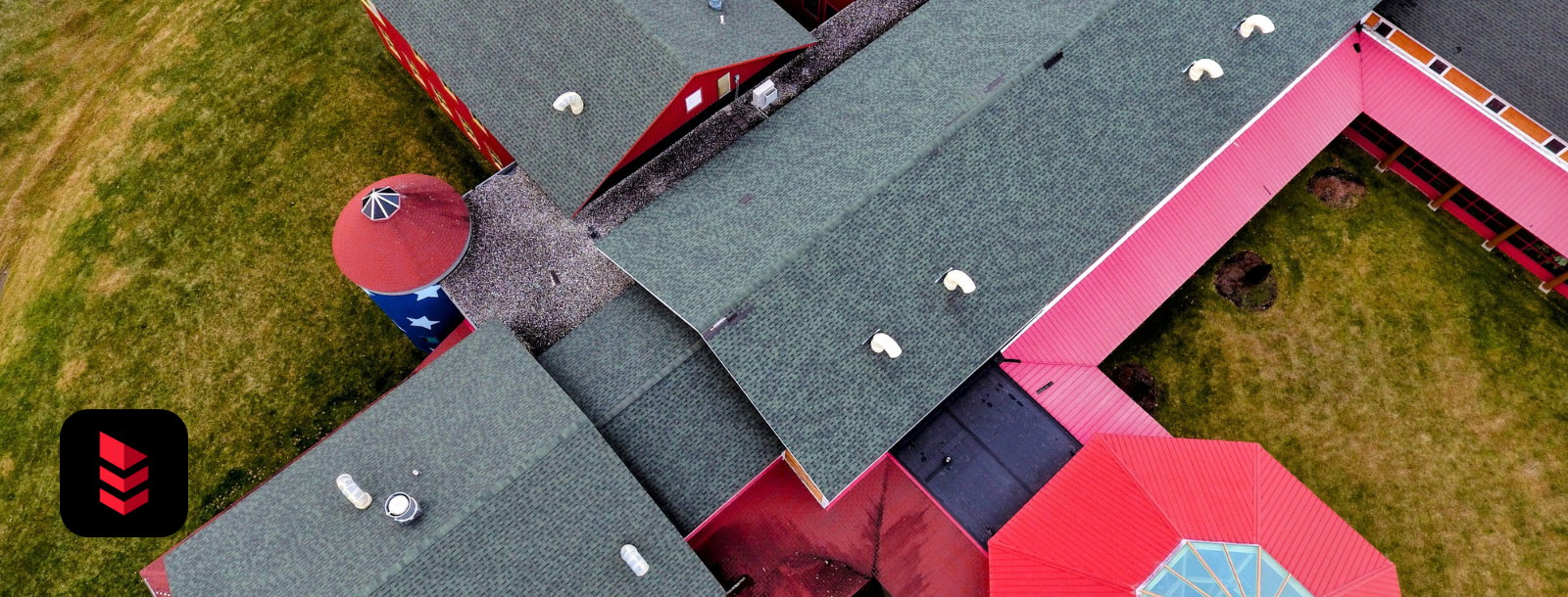 Colorful Vermont commercial property with new green shingle roofing installed by RoofPros.Plus